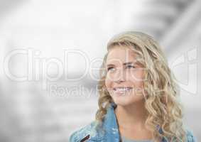 Thoughtful woman smiling against blurred background