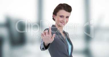 Smiling businesswoman touching imaginary screen