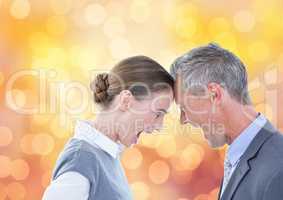 Aggressive business people with head to head screaming over bokeh