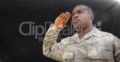 Soldier saluting against black background with grunge overlay and flare