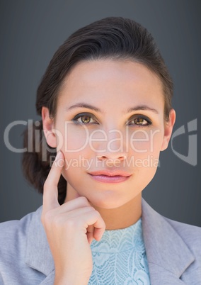 Close up of business woman thinking against grey background