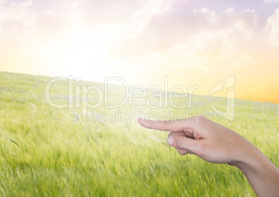 Hand pointing in  air of peaceful landscape