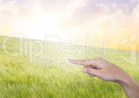Hand pointing in  air of peaceful landscape