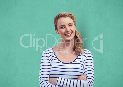 Confident woman with arms crossed over turquoise background