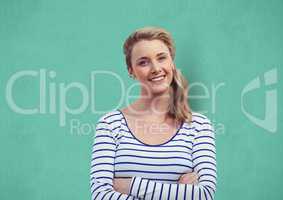 Confident woman with arms crossed over turquoise background