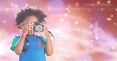 Child photographing over blue background