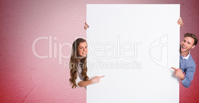 Couple pointing at blank bill board
