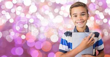 Portrait of smiling boy with tablet PC over bokeh
