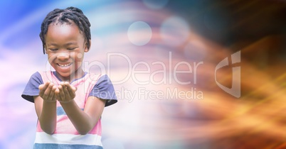 Smiling girl looking at cupped hands over bokeh