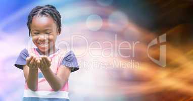 Smiling girl looking at cupped hands over bokeh