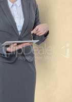 Midsection of businesswoman pointing at tablet PC