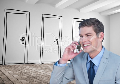 Smiling businessman using smart phone against drawn doors