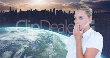 Shocked businesswoman by globe against silhouette city