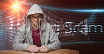 Hacker wearing hooded shirt against screen