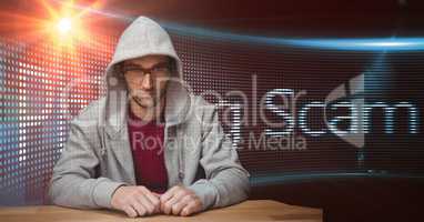 Hacker wearing hooded shirt against screen