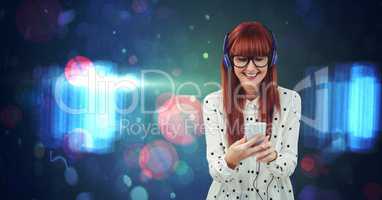 Redhead woman listening to music against abstract background