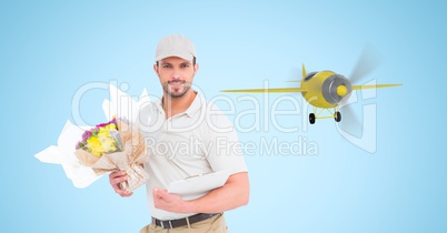 Delivery man holding bouquet against airplane