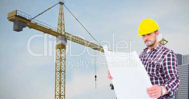 Architect holding blueprint against crane