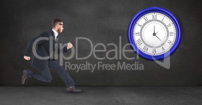 Businessman running while looking at clock