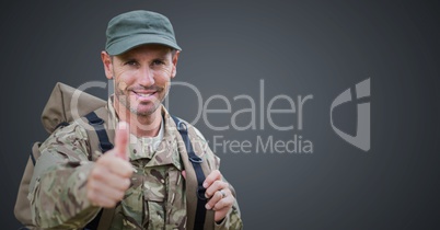 Soldier thumbs up against grey background