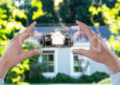 house with cloud on futuristic device in front of a house
