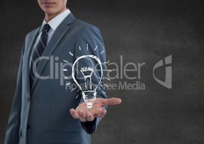 Business man hand out with lightbulb doodle against grey wall