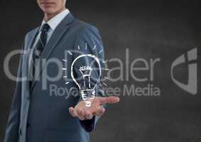 Business man hand out with lightbulb doodle against grey wall