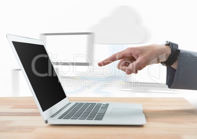 Hand pointing at laptop against blurry screens