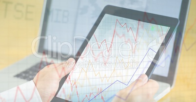 Business person holding digital tablet with graph overlay