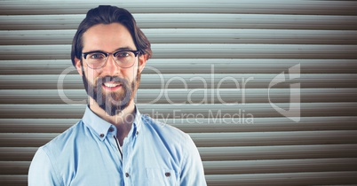 Hipster smiling against wall
