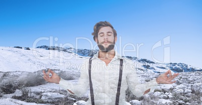 Double exposure man meditating with snow covered mountain in background