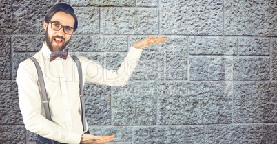Hipster gesturing against wall
