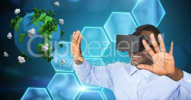 Smiling businessman with arms raised wearing VR glasses by low poly earth