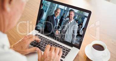 Cropped image of businessman video conferencing with colleagues on laptop