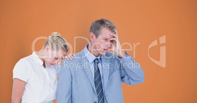 Tensed business people over orange background