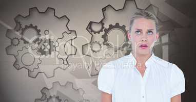 Scared businesswoman looking up against gear background