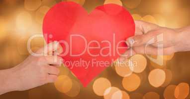 Cropped image of hands holding heart shape against bokeh