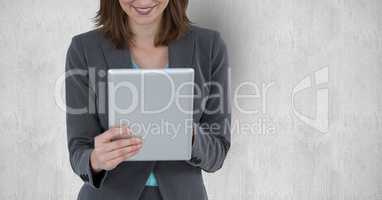 Midsection of businesswoman holding tablet PC