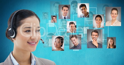 Smiling female customer care representative wearing headphones against flying portraits