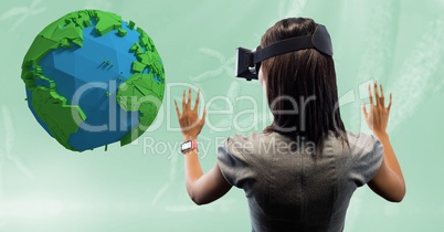 Rear view of businesswoman looking at low poly earth on VR glasses