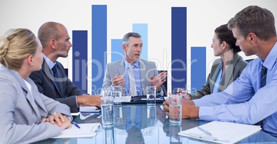 Business people discussing in meeting with graph in background