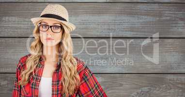 Confident female hipster wearing sunhat against wall