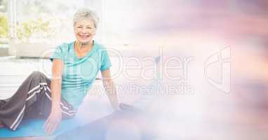 Fit senior woman exercising in yoga class