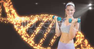 Smiling woman lifting dumbbells against DNA structure
