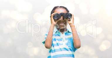 Smiling girl looking through binoculars over blur background