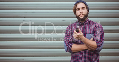 Hipsters holding smoking pipe against wall