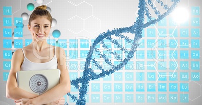 Smiling fit woman holding weight machine by DNA structure