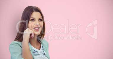 Thoughtful female hipster smiling against pink background