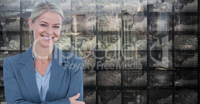 Smiling businesswoman against screens