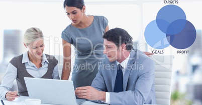 Male and female colleagues using laptop by graphics